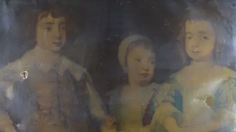 National Trust/Mike Hodgson A close-up of an 18th Century print of a portrait of children of Charles II, hidden under layers of yellow varnish and with a hole on the right