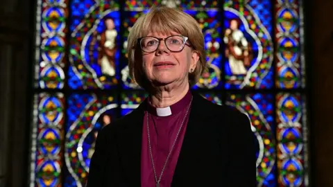 AFP via Getty Images Britain's new Archbishop of Canterbury-designate, Sarah Mullally, poses for a photograph in The Corona Chapel at Canterbury Cathedral, south east England on October 3, 2025