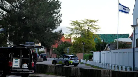 Reuters A police vehicle is seen as police officers investigate two blasts near the Israeli embassy in Copenhagen, Denmark, October 2, 2024.