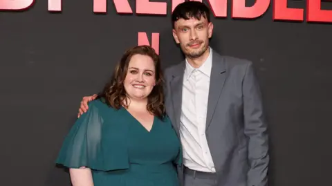 Cast members Richard Gadd and Jessica Gunning astatine  a photograph  call. Both are dressed formally. Gadd successful  grey suit   with achromatic  garment  and Gunny successful  a greenish  dress.