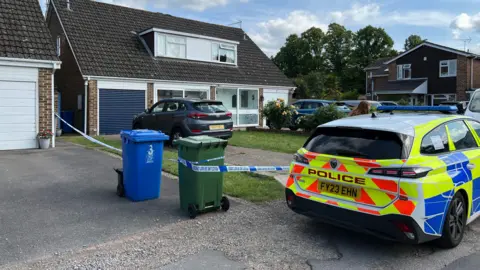 A police car and police tape outside a detached house in Maidenhead.