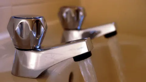 BBC Two taps pouring water into a yellow bath.