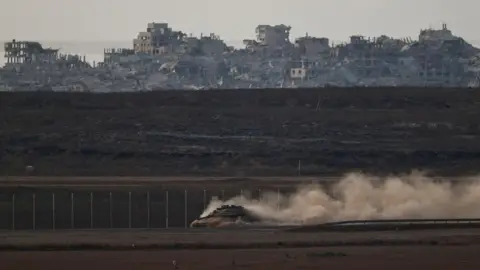 Reuters An Israeli tank moves next to the Gaza perimeter fence, in southern Israel (8 September 2025)