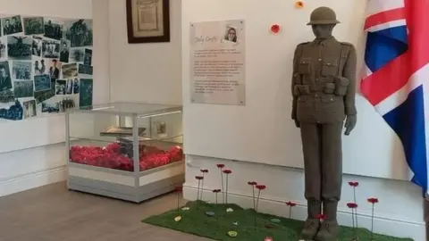 Erewash Borough Council A 6ft crochet WWII soldier next to a Union Jack.