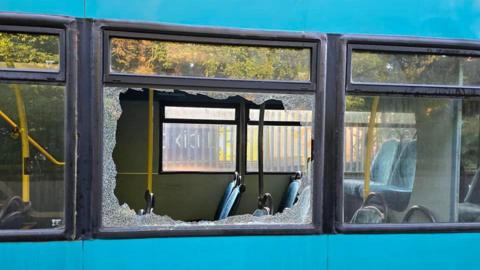 The bus with its windows smashed 
