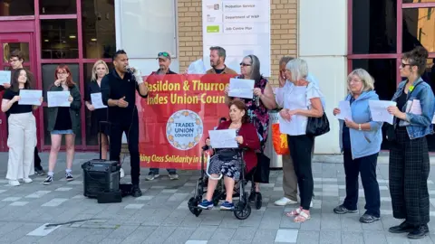 A group of people protesting outside the Basildon Centre