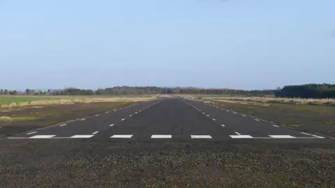James Towill A view across an airfield with a runway 