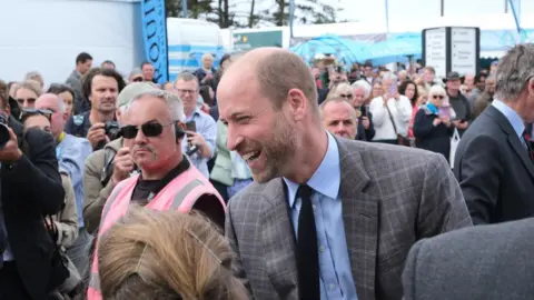 PA Media Prince William laughs while talking to members of the public at the Royal Cornwall Show.