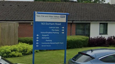A sign outside of the Tees Esk and Wear Valleys building in Stockton-on-Tees. It reads '163 Durham Road' and then directions for different services.