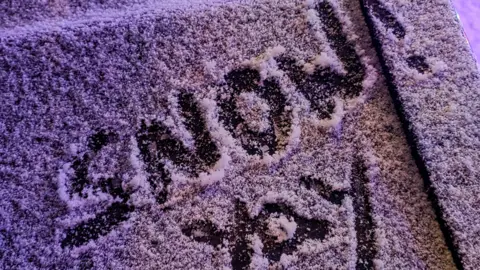 whethertheweatherbefine/WEATHERWATCHERS A close-up of the words "Snow! Yay" written in a thin dusting of snow on a car windscreen