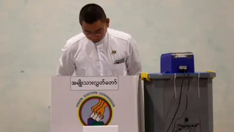 A man casts a ballot in the general election in Yangon, Myanmar.