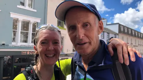 Ella Scott, who has braided light brown hair, with Joss Naylor, who is wearing a cap and a fleece.