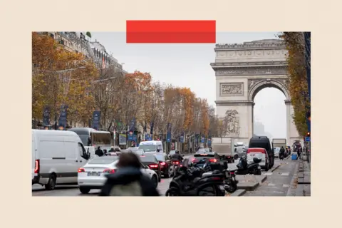 Bloomberg via Getty Images Traffic on the Champs Elysee near the Arc de Triomphe in Paris, France

