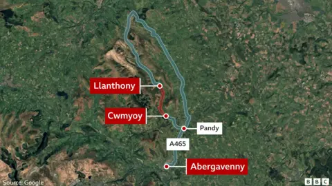 BBC/ Google An aerial satellite image showing the location of the affected roads. The road closure is marked in red. 