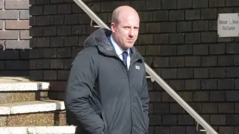 Eddie Mitchell Mike Sinden looking to camera on the steps outside Hove Crown Court