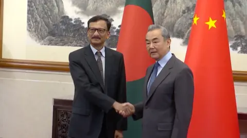 CCTV Chinese Foreign Minister Wang Yi shakes hands and meets with Adviser for Foreign Affairs of the Interim Government of Bangladesh Touhid Hossain, attendees on January 21, 2025 in Beijing, China.