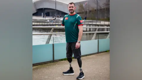Handout photo issued by the Army Benevolent Fund of Andy Reid, an Afghanistan veteran and triple amputee, during a training walk for the TCS London Marathon at Salford Quays.