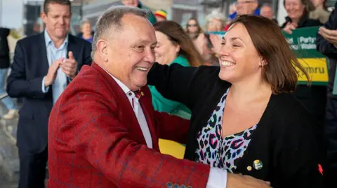 Getty Images Lindsay Whittle hugs Plaid Cymru Senedd member Heledd Fychan on the steps of the Welsh Parliament building. Plaid leader Rhun ap Iorweth can be seen clapping on the left hand side of the picture.
