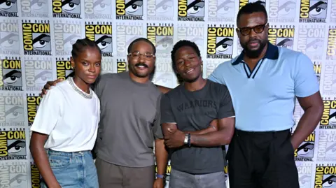 Getty Images Letitia Wright, Ryan Coogler, David Jonsson and Winston Duke at the Marvel Studios Panel at Comic Con. 