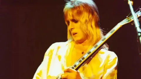 Getty Images Mick Ronson playing a guitar