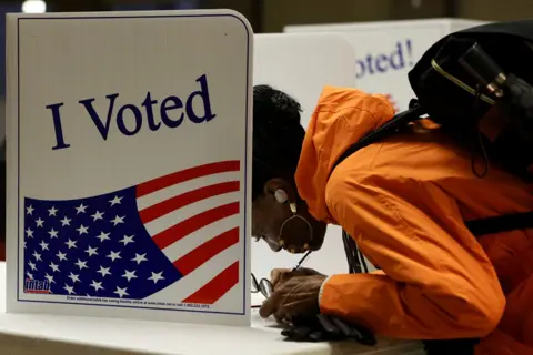 Quinn Glabicki/Reuters A person votes in the 2024 presidential election on Election Day, at Pittsburgh Manchester School in Pittsburgh, Pennsylvania, 5 November 2024 
