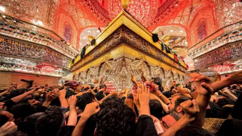 Getty Images Shia Muslim devotees arrive to receive a blessing at the tomb of Imam Hussein, grandson of the Prophet Mohammed, at the Imam's shrine in the central Iraqi holy city of Karbala on September 6, 2023, during the Arbaeen religious festival commemorating his seventh-century assassination.