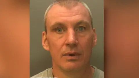 Sussex Police A police custody image shows Donald Excell, with short grey hair, looking directly at the camera. 