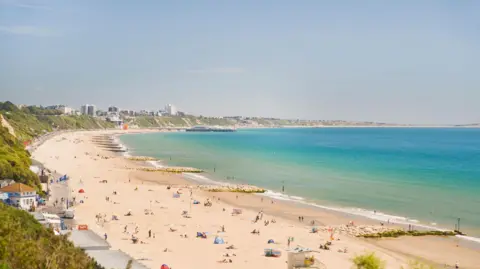 Bournemouth beach in the sunshine with swimmers and sunbathers
