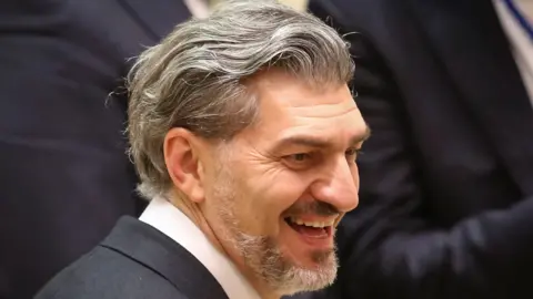 Reuters Mikheil Kavelashvili smiles after he was elected the country's new president in the parliament, in Tbilisi, Georgia on 14 December