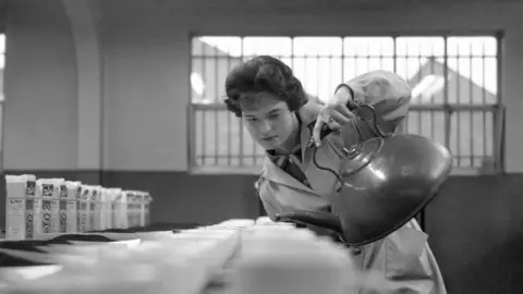 Getty Images Vivyan Barton of Harborne prepares samples of tea for tasting at the Typhoo factory in Birmingham on in February 1960