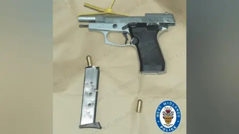 West Midlands Police A silver and black hand gun with gold bullets