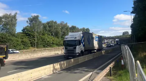 Lorries drives along the M62 on a sunny day near Rochdale 