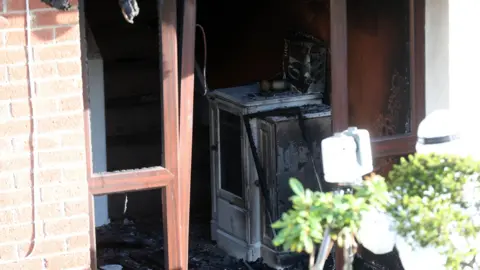 Pacemaker A view of the front door showing a burned hall table. 