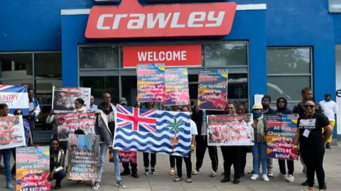BBC/George Carden Chagos Islanders outside K2 Crawley