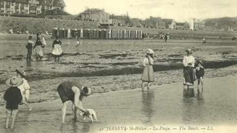 Lord Coutanche Library, Société Jersiaise A black and white vintage photograph of Victoria Marine Lake showing people using the water.