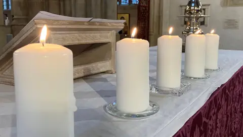 Jon Wright/BBC Five candles on a church alter