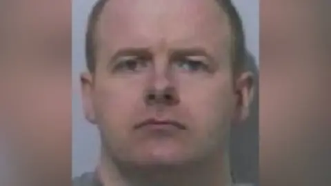 Northumbria Police Mugshot of John Henderson. He is clean shaven with short fair hair