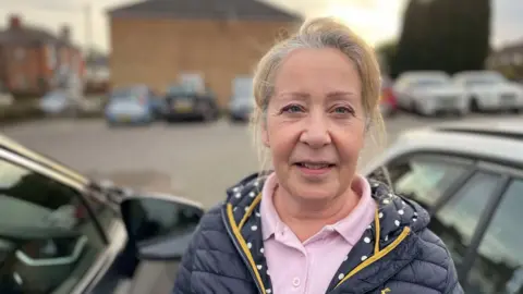 A woman stood in a car park