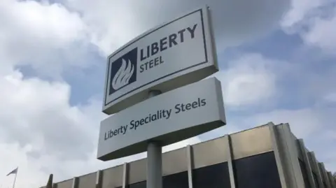 An image of a sign with LIBERTY STEEL written in dark blue on a white background
