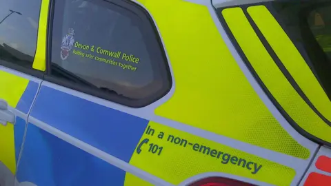 The rear window of a Devon and Cornwall Police car. 
