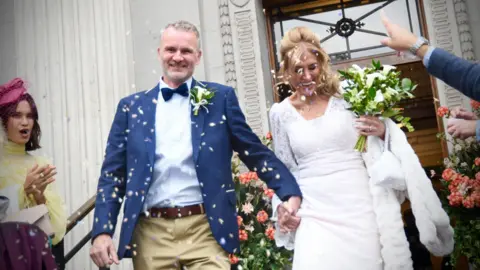 Emma Lynch / BBC Ean Reiner and Daniela Pelusi are greeted by family and friends