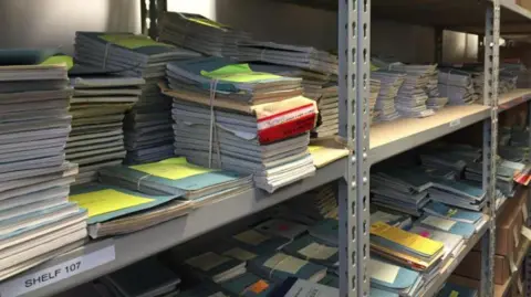 The Hillsborough archive at the IOPC’s Warrington office. There are notebooks piled high on shelves. Some are bound together with elastic bands.