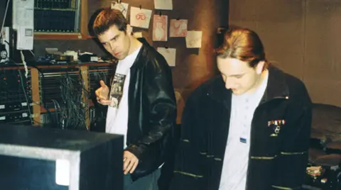 Nick Brine Nick with Ian Brown of the Stone Roses in Rockfield Studios. They are standing in the studio with music recording equipment around them.