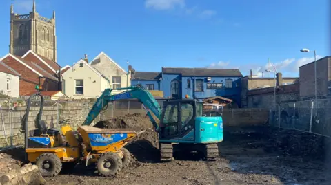 LDRS/John Wimperis Construction site at Danes Lane in Keynsham. Construction vehicles and machinery can be seen in the site which is fenced off to the public.