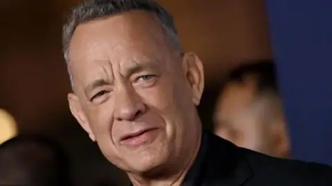 Getty Images Close-up shot of Tom Hanks looking towards the camera, with a blurred background