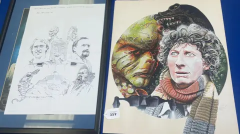 Molly Smith/BBC Two pieces of artwork. One is a sketch-style drawing possibly of a promotional poster, with character portraits positioned around the Tardis. The other artwork is in colour and features a scarf-clad Tom Baker as the doctor, alongside one of his many nemesis.