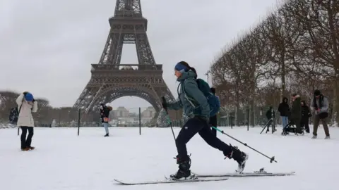 Reuters A woman skis on the snow-covered grounds near the Eiffel Tower in Paris