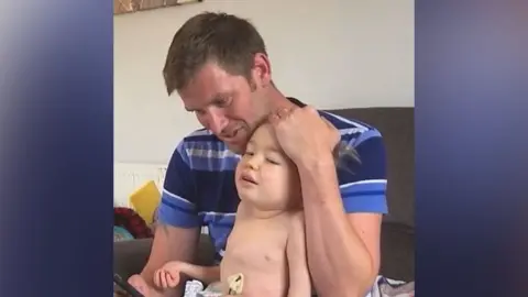Family photo Darren Garwood said his son Jackson sitting together on the sofa