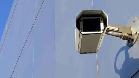 A CCTV camera on the side of a building.