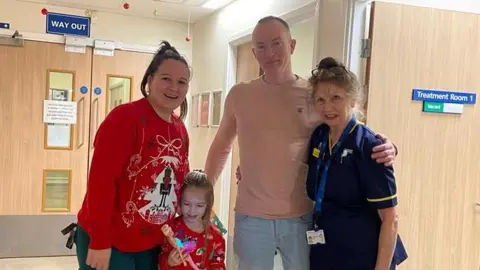 Doreen Lewis Ms Lewis (right) with a family she helped in Frome